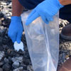 An EPA worker takes a soil sample to determine levels of toxicity
